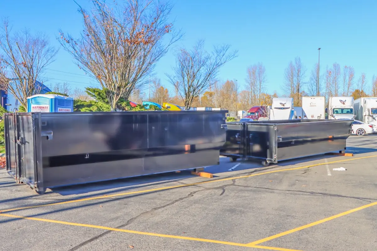 Professional dumpster rental service with roll-off container on residential driveway in St. Augustine Shores